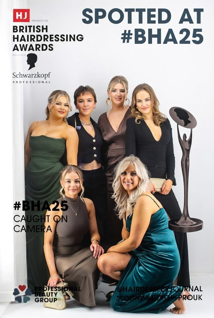 6 girls posing in a magazine cover photo booth at the british hairdressing awards london