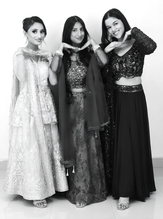 a black and white image of three girls in a glam photo london